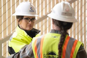 Ally Isom in conversation at a Sunroc job site